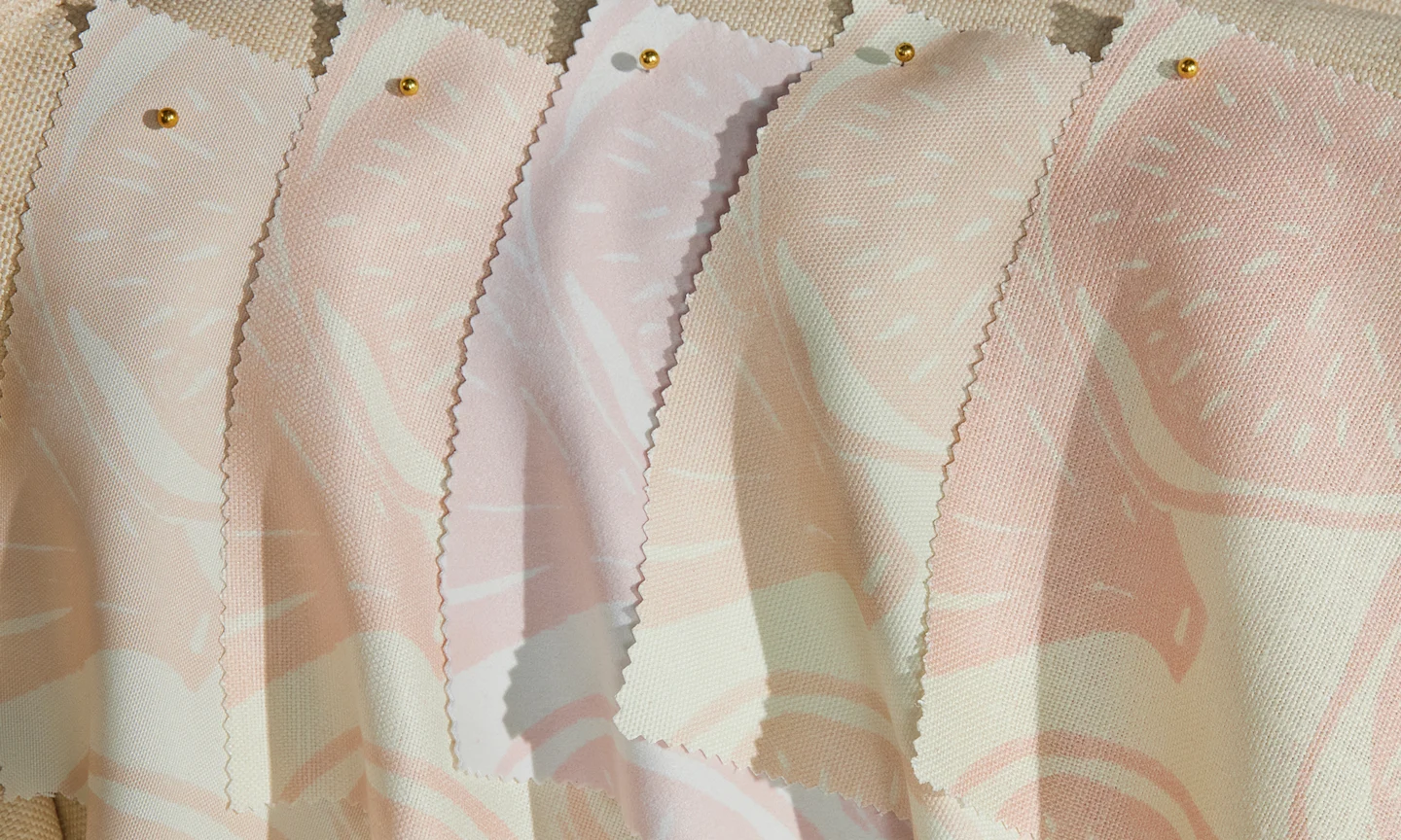 A selection of elegant fabrics pinned to a settee