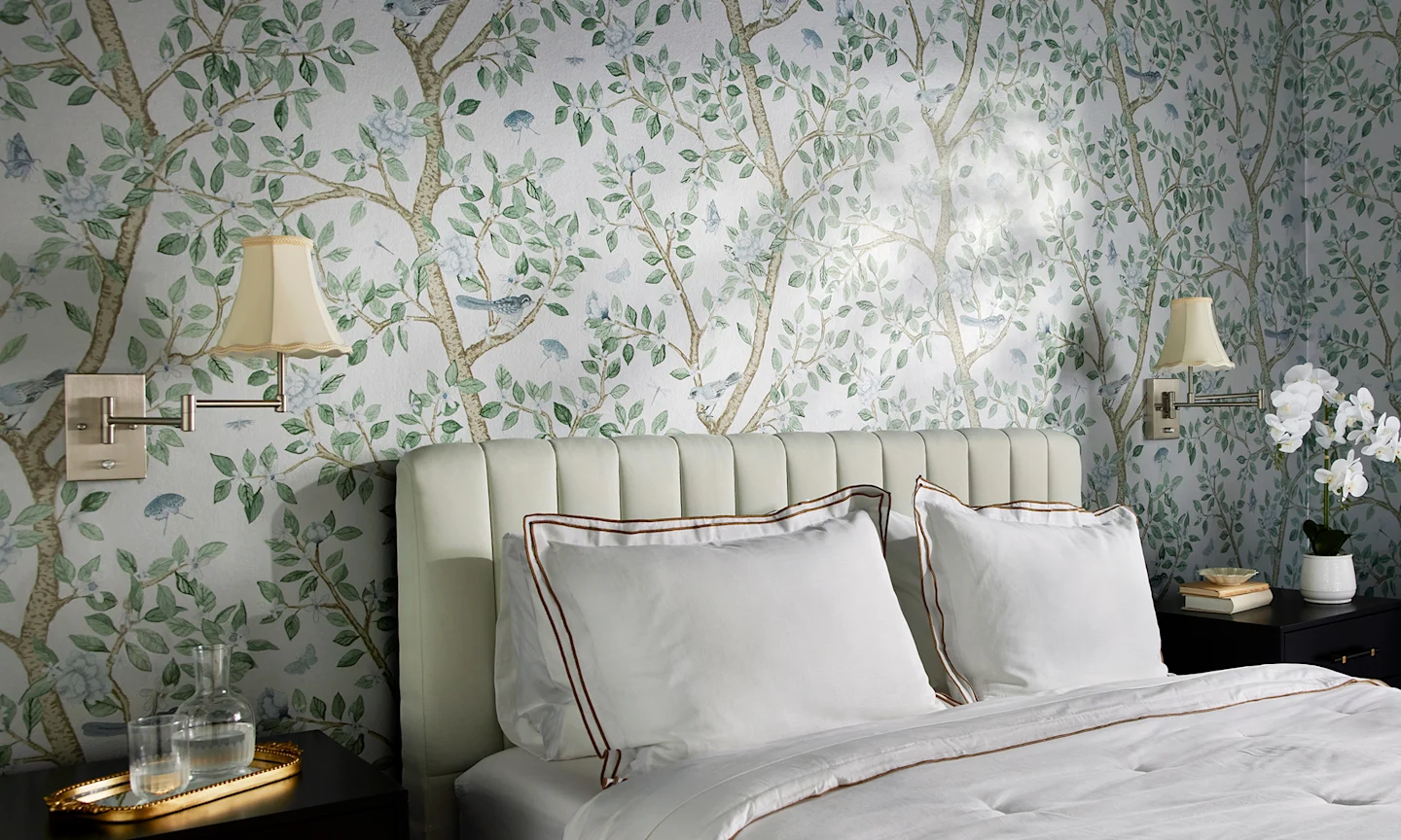 Rustic cabin bedroom with neutral floral wallpaper and christmas themed decor.