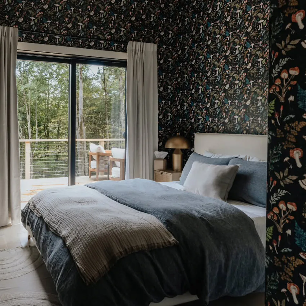 Cabin bedroom with mushroom wallpaper.