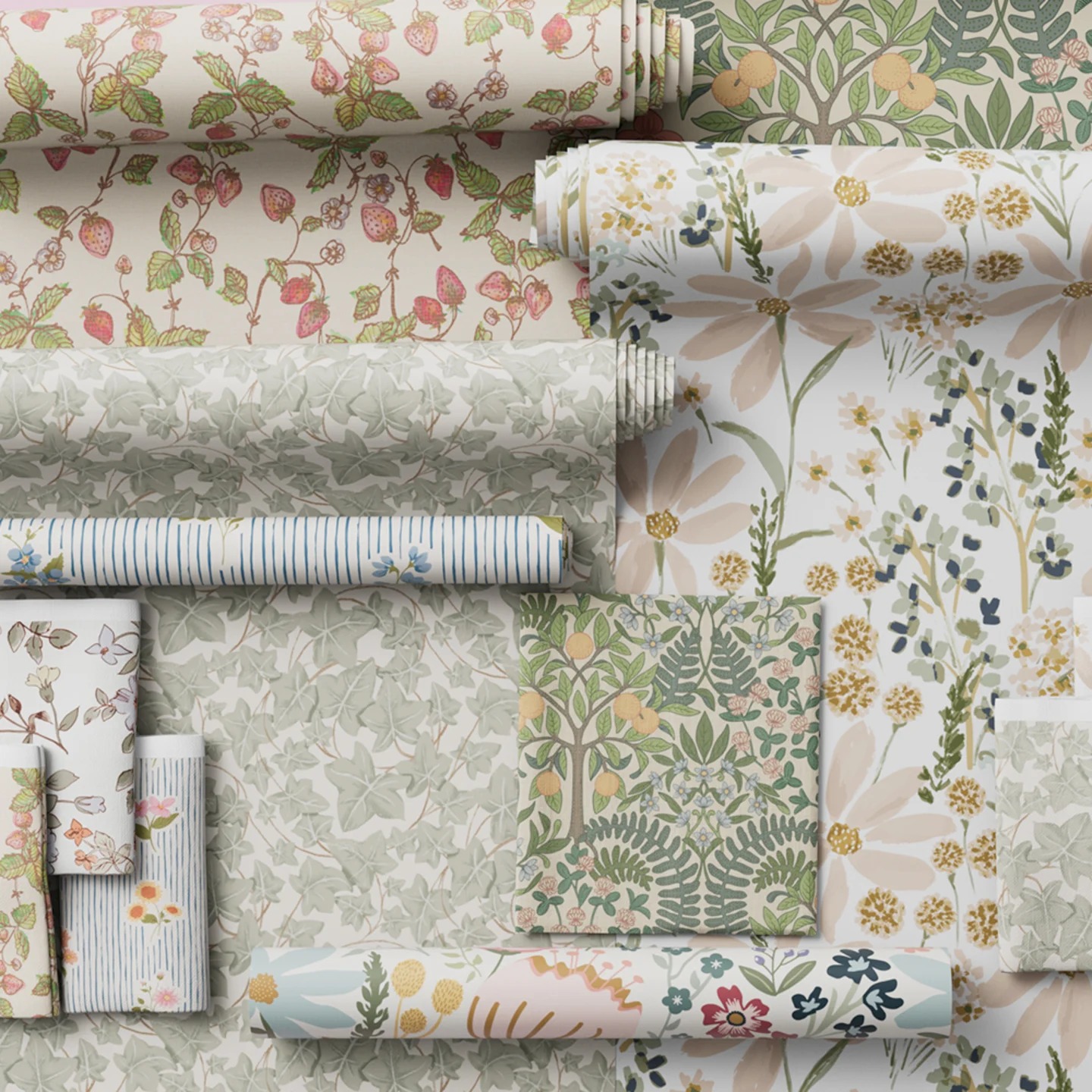 Wallpaper rolls and fabrics from the cottagecore collection styled together.