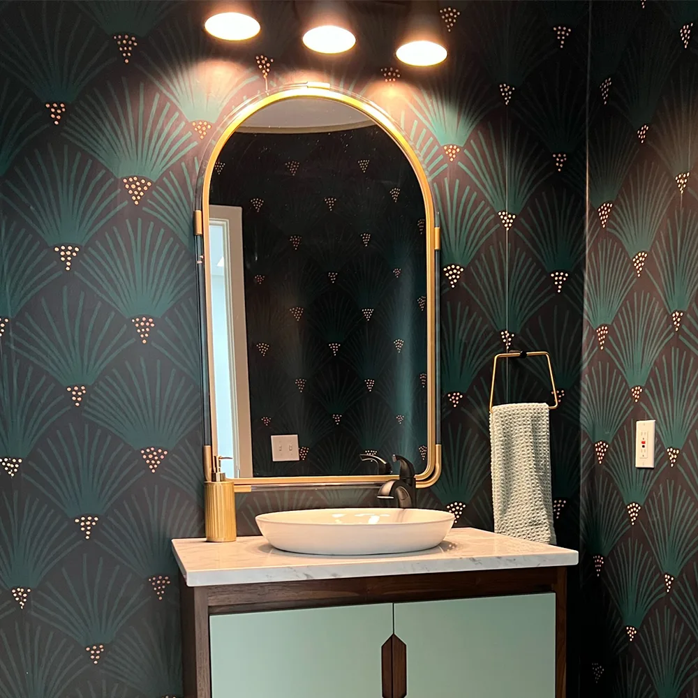 Bathroom with navy and teal art deco floral wallpaper.