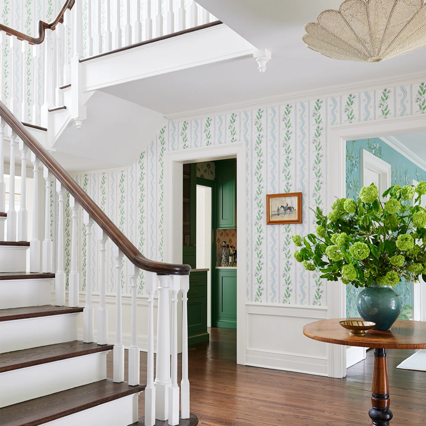 Foyer with floral stripe wallpaper.