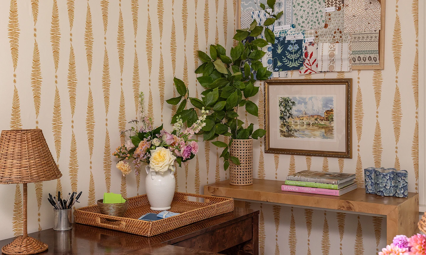 Gold fern leaf on cream vertical stripe wallpaper in a home office.