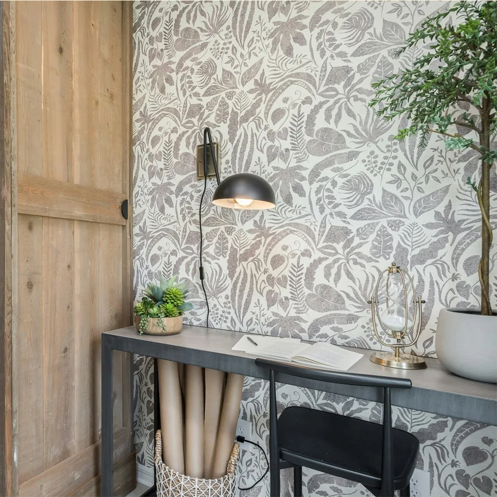 Pocket office space with neutral botanical wallpaper.