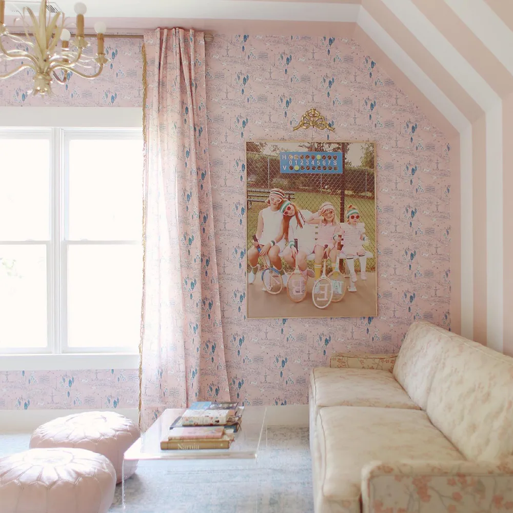 Pink toile wallpaper and matching curtains in girls hangout space.