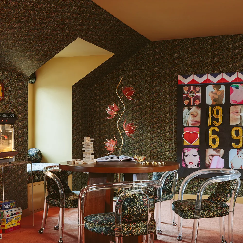 Dining room with green wallpaper and matching upholstery.