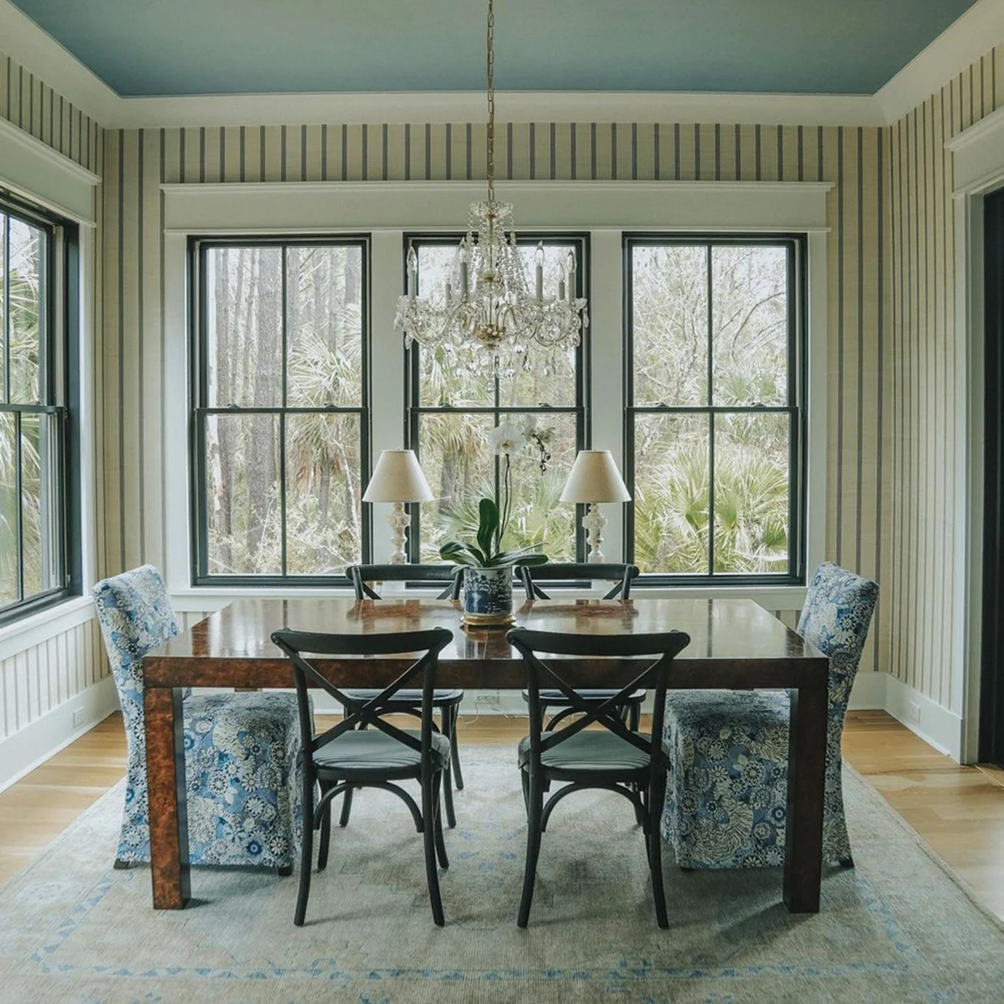 Dining room with striped wallpaper.