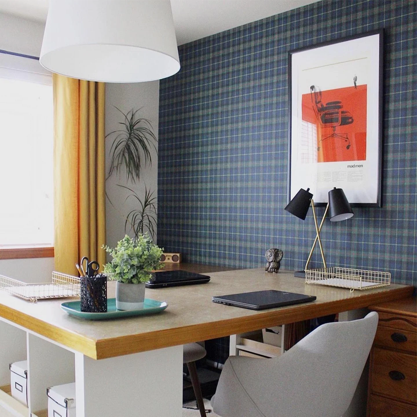 Home office with navy plaid wallpaper on one wall.