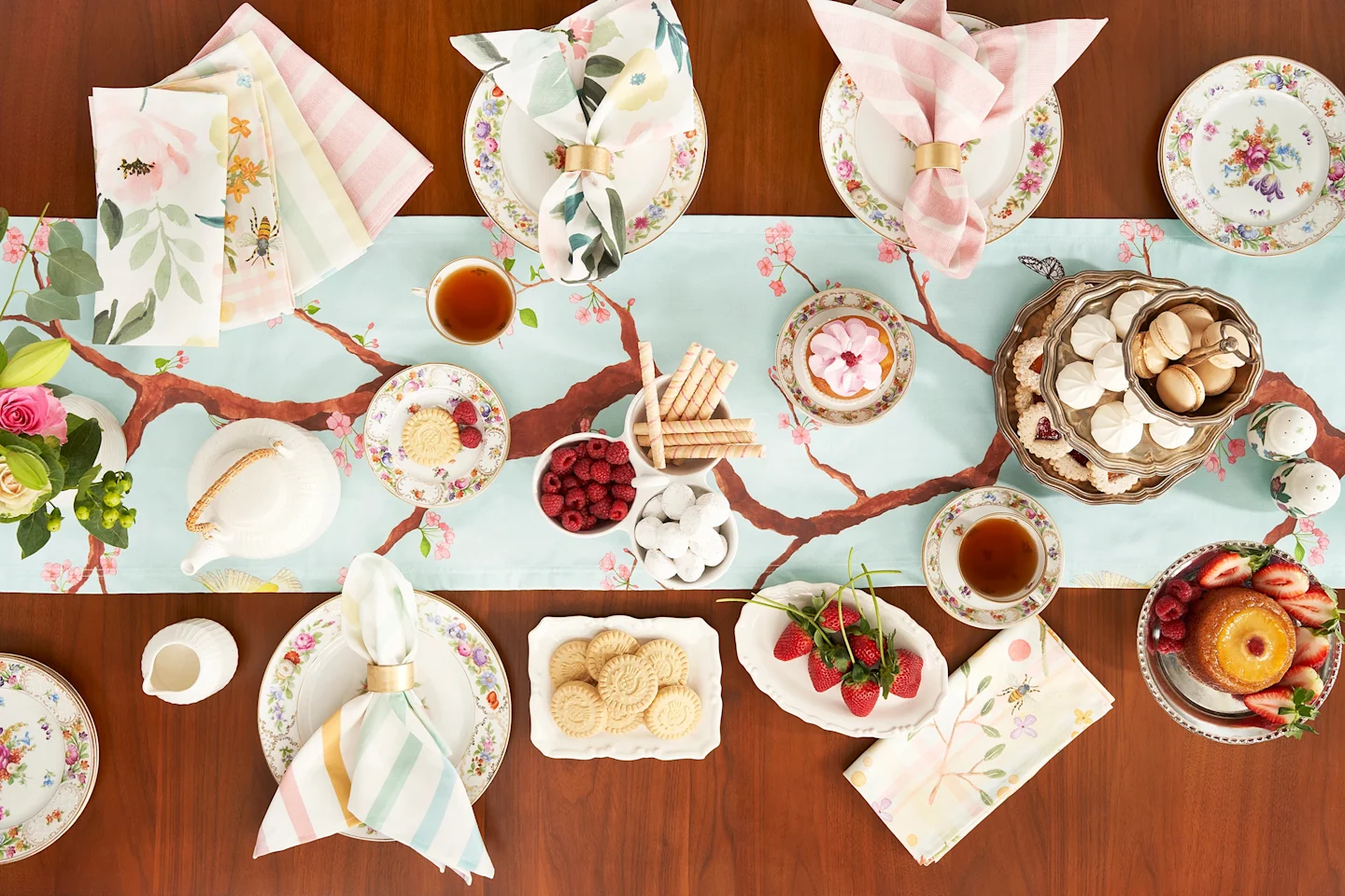 Pale pink and blue table linens on a set table.