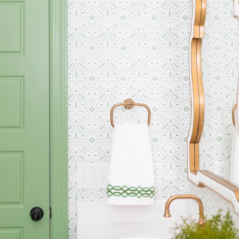 Green and blue ikat wallpaper in a bathroom.