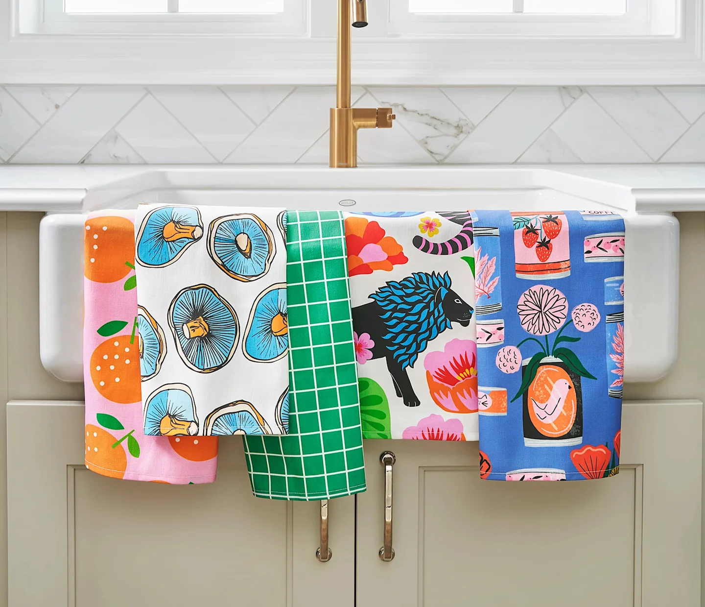 Colorful tea towels draped over a sink