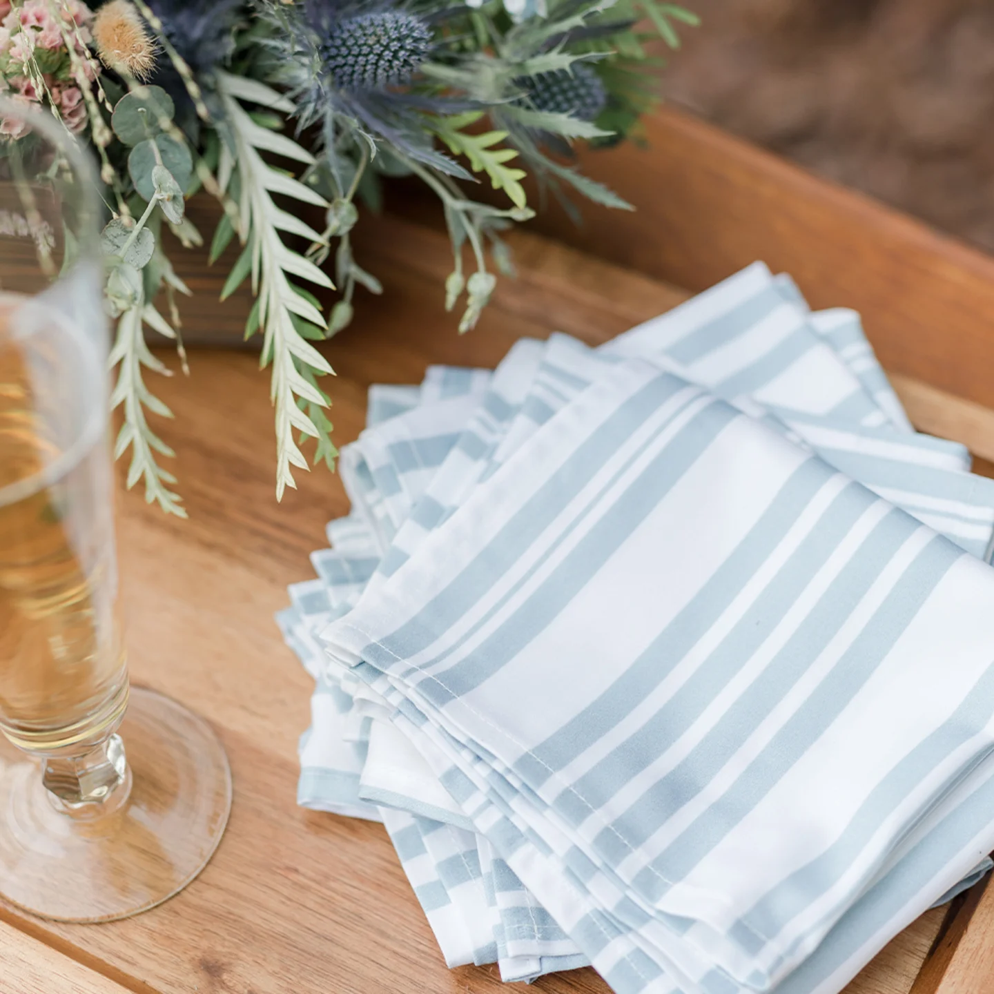 Two sets of cocktail napkins on table with lemon slices