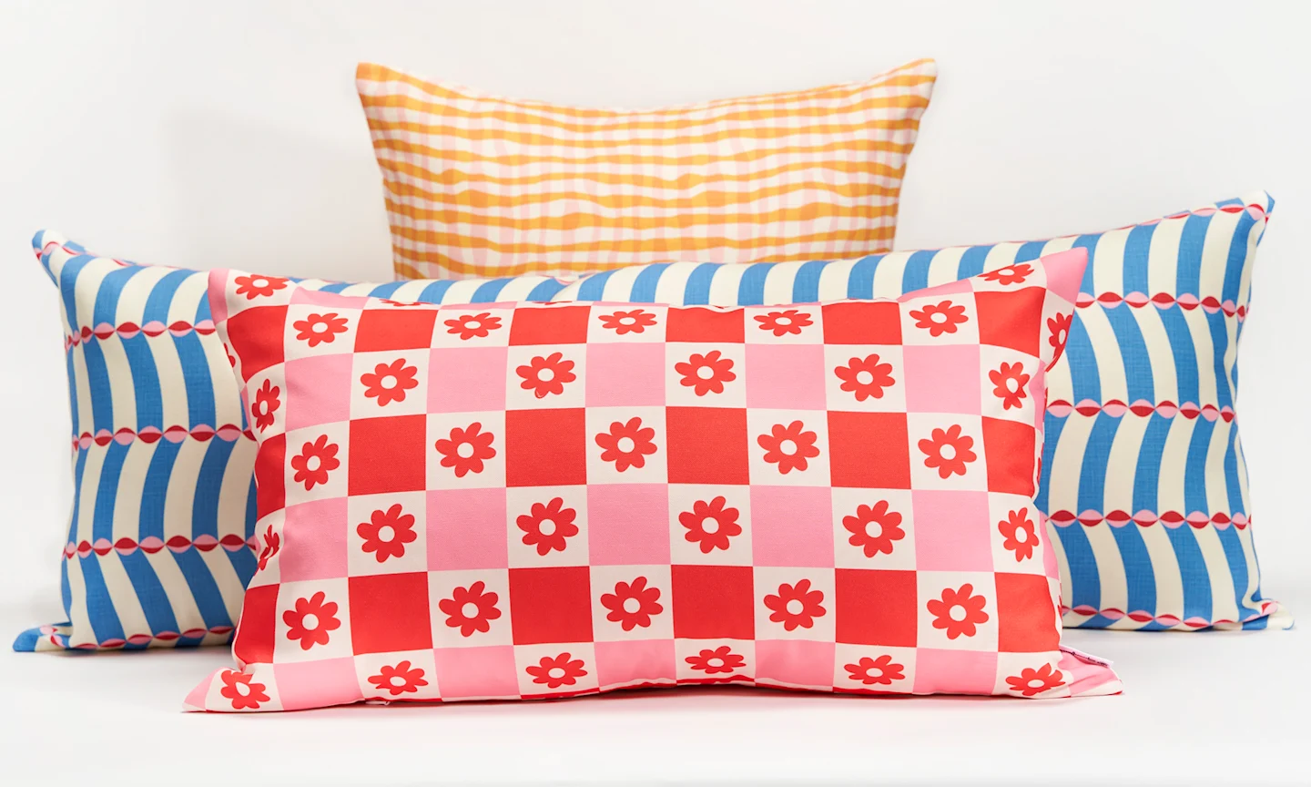 Various throw pillows with different patterns on a white background.