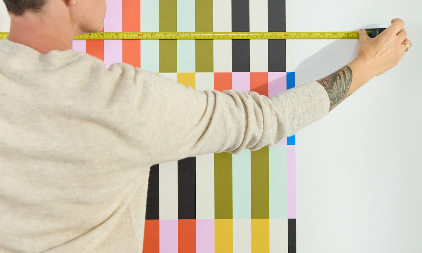 Person measuring walls for wallpaper