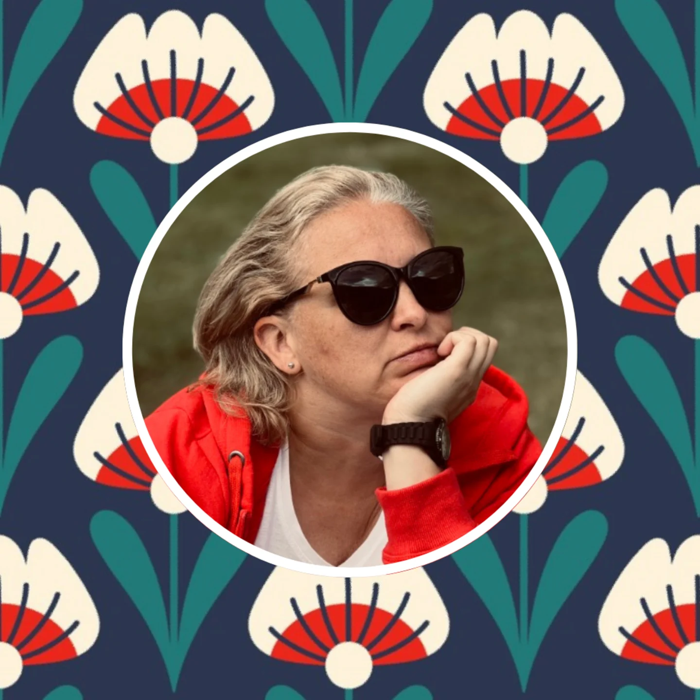 Headshot of Elvyra with one of her prints in the background.